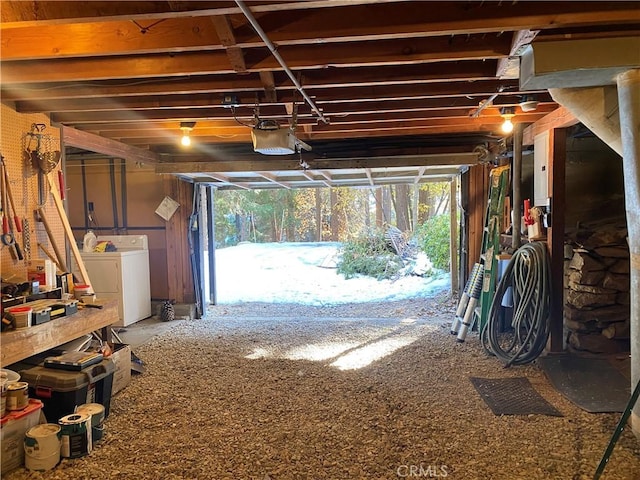 garage with washer / clothes dryer and a garage door opener