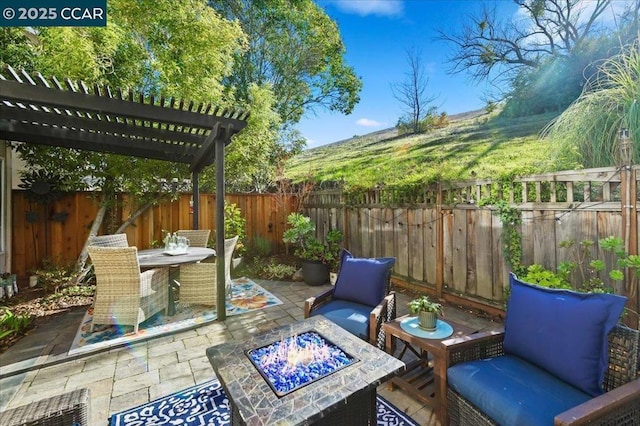 view of patio / terrace with a pergola and a fire pit