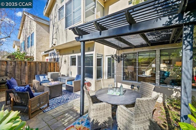 view of patio featuring a pergola and an outdoor living space with a fire pit