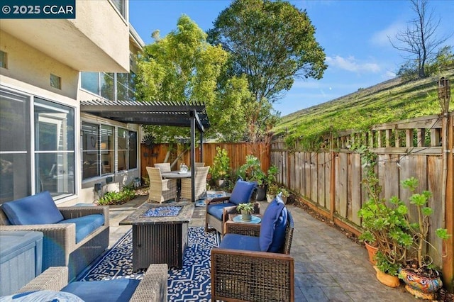 view of patio with a pergola and an outdoor living space with a fire pit