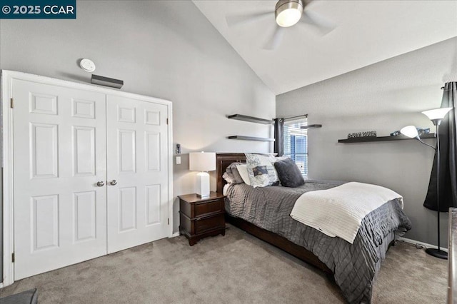 bedroom featuring light carpet, a closet, high vaulted ceiling, and ceiling fan