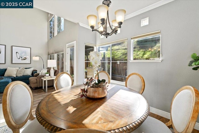 dining room with a notable chandelier, hardwood / wood-style floors, and ornamental molding