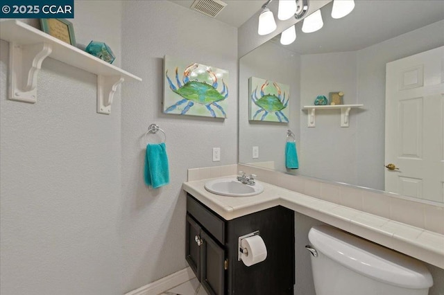 bathroom with toilet and vanity