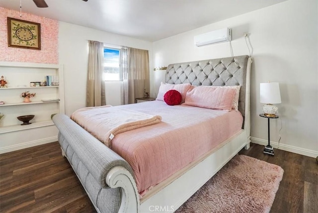 bedroom with ceiling fan, dark hardwood / wood-style floors, and a wall mounted air conditioner