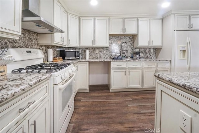 kitchen featuring white cabinets, white appliances, wall chimney range hood, and dark hardwood / wood-style floors