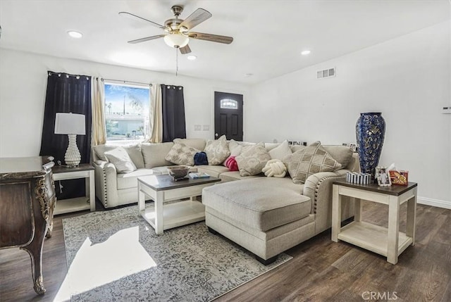 living room with ceiling fan and dark wood-type flooring