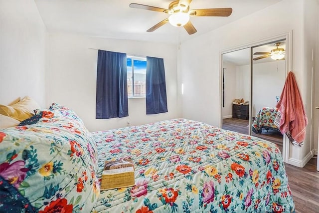 bedroom with ceiling fan, a closet, vaulted ceiling, and hardwood / wood-style floors