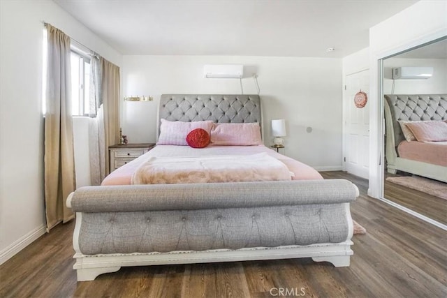 bedroom with a closet, dark hardwood / wood-style floors, and a wall mounted air conditioner