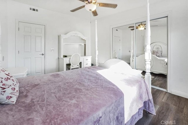 bedroom featuring ceiling fan, dark hardwood / wood-style flooring, and a closet