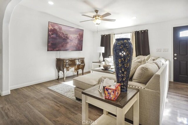 living room with ceiling fan and hardwood / wood-style flooring