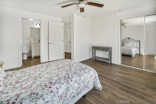 bedroom featuring ceiling fan, ensuite bath, a closet, and dark hardwood / wood-style floors