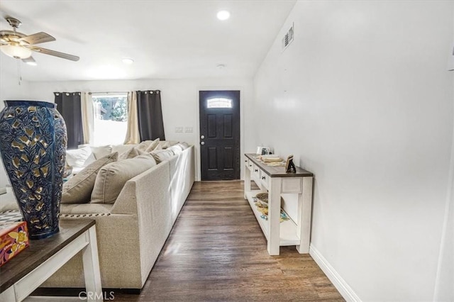 living room with ceiling fan and dark hardwood / wood-style flooring