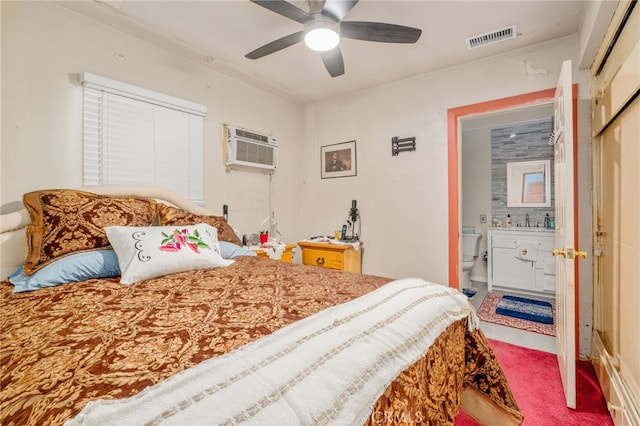 bedroom featuring ensuite bath, ceiling fan, sink, a wall mounted AC, and carpet floors