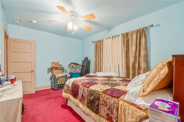 bedroom featuring carpet, ceiling fan, and a textured ceiling