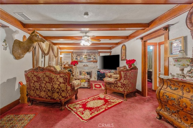 carpeted living room with ceiling fan, beam ceiling, and a textured ceiling