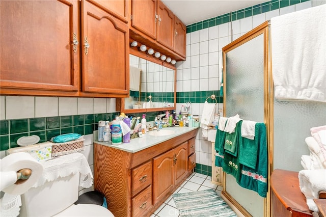 bathroom featuring tile patterned flooring, vanity, tile walls, and backsplash