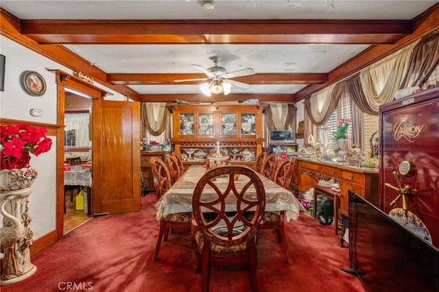 carpeted dining room featuring beam ceiling, a textured ceiling, and ceiling fan