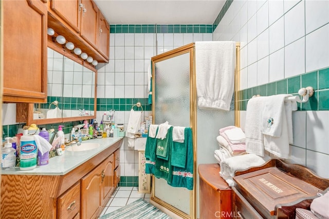 bathroom with tile patterned floors, vanity, and tile walls