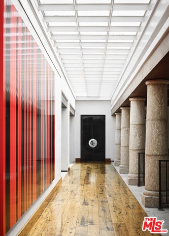 corridor with hardwood / wood-style flooring