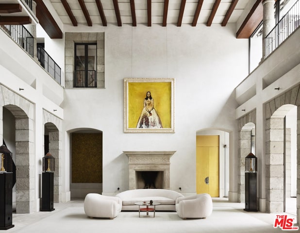 living room with beam ceiling and high vaulted ceiling