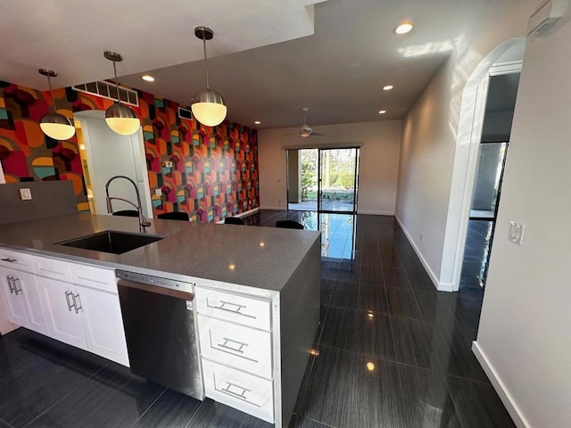 kitchen with white cabinetry, dishwasher, ceiling fan, sink, and decorative light fixtures