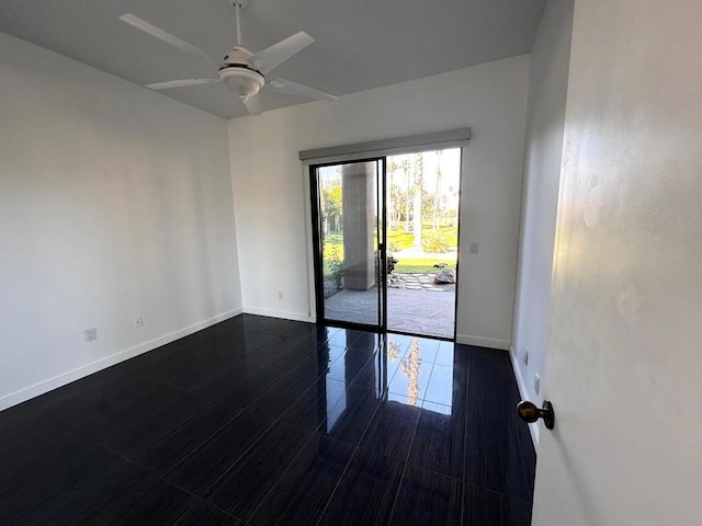 spare room with ceiling fan and dark hardwood / wood-style flooring