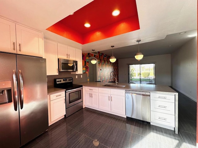 kitchen featuring kitchen peninsula, white cabinets, and appliances with stainless steel finishes