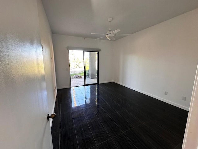 tiled spare room with ceiling fan