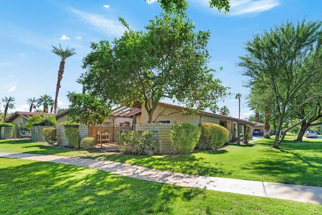 ranch-style house featuring a front lawn