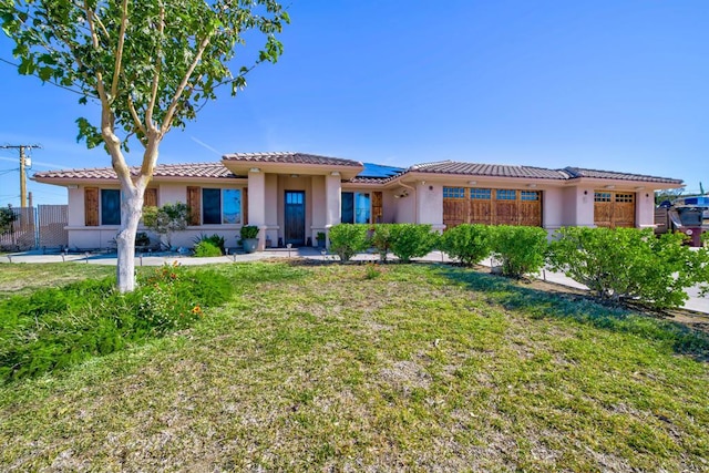 view of front of property with solar panels and a front lawn