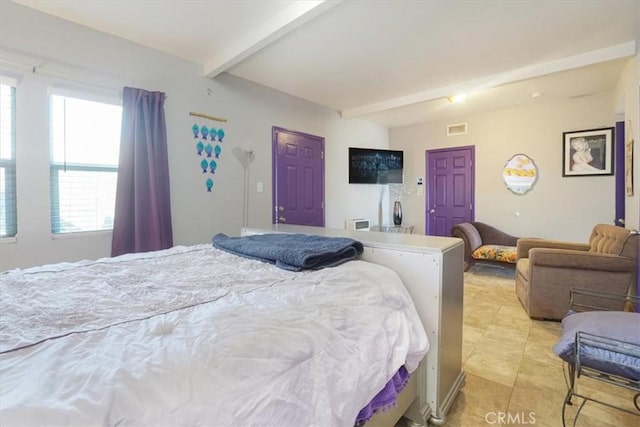 bedroom with beam ceiling