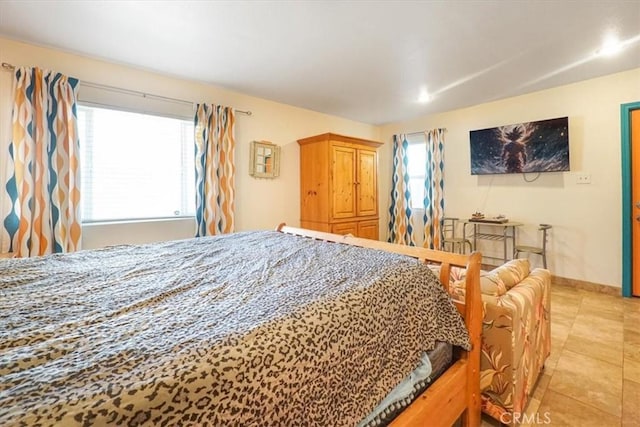 tiled bedroom with multiple windows