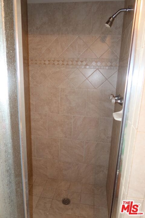 bathroom with a tile shower