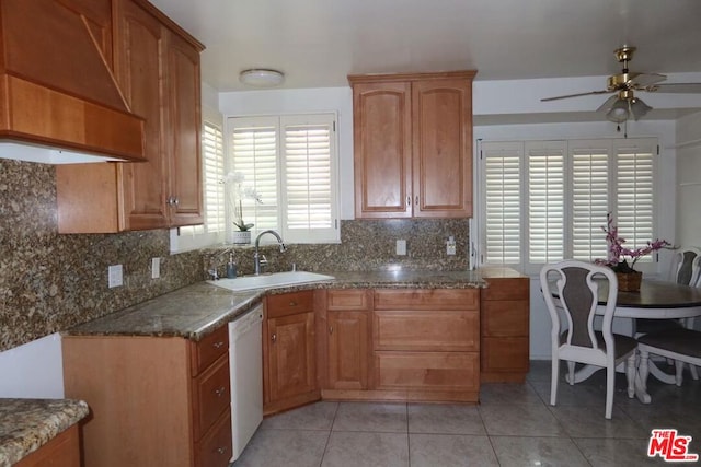 kitchen with ceiling fan, sink, white dishwasher, light tile patterned flooring, and custom range hood