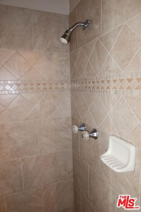 bathroom with tiled shower