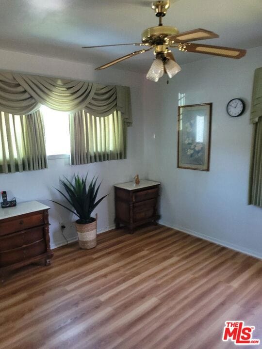 unfurnished bedroom featuring ceiling fan and wood-type flooring