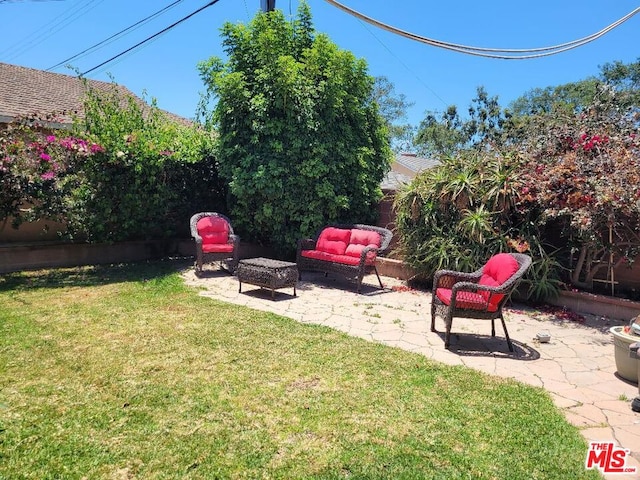 view of yard with an outdoor living space and a patio