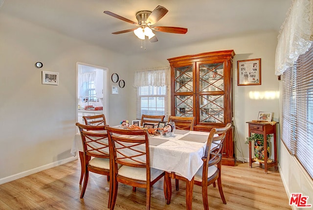 dining space featuring light wood-type flooring and ceiling fan