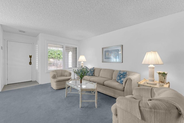 living room featuring carpet floors and a textured ceiling