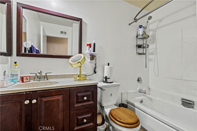 full bathroom featuring bathing tub / shower combination, vanity, and toilet