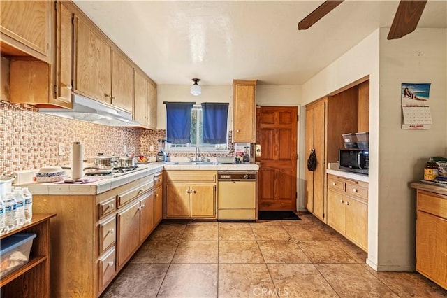 kitchen with decorative backsplash, white dishwasher, ceiling fan, sink, and light tile patterned flooring