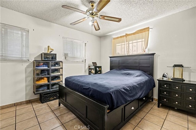 tiled bedroom featuring a textured ceiling and ceiling fan