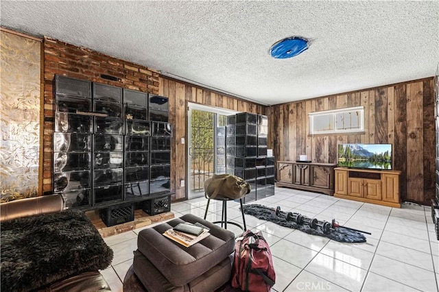 tiled living room featuring wood walls and a textured ceiling