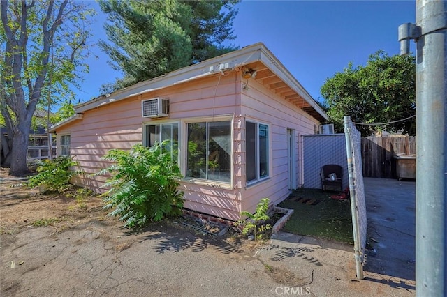 view of property exterior featuring a wall mounted AC