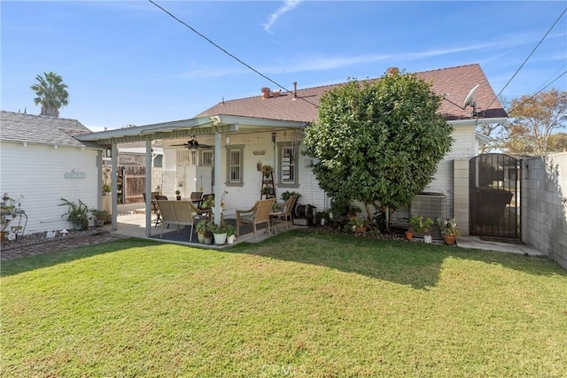 view of front of home with a patio, a front yard, and ceiling fan