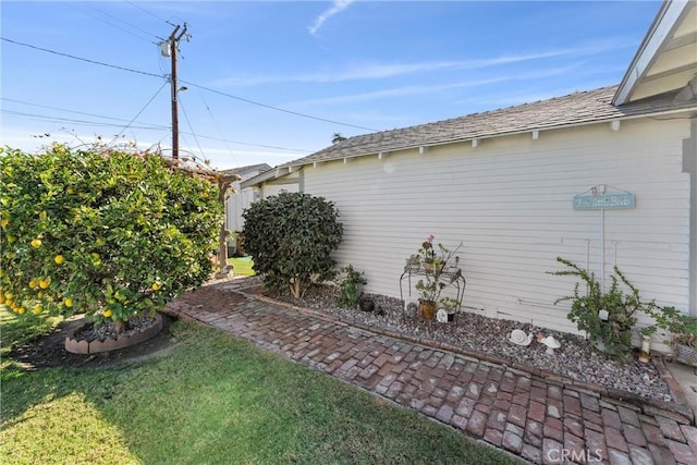 view of side of home featuring a lawn