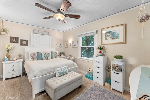 bedroom featuring ceiling fan, carpet flooring, and a textured ceiling