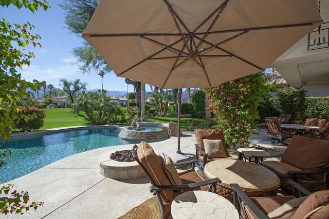 view of pool featuring a patio area and an in ground hot tub