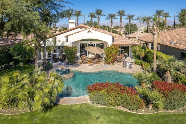 view of pool featuring an in ground hot tub and a patio area