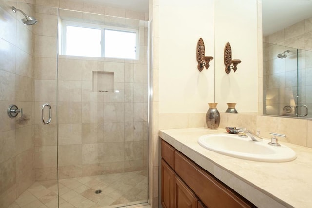 bathroom with vanity and a shower with shower door